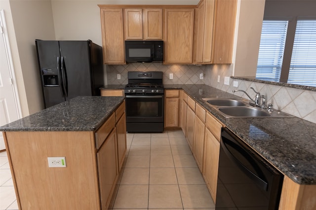 kitchen with sink, dark stone counters, decorative backsplash, light tile patterned floors, and black appliances