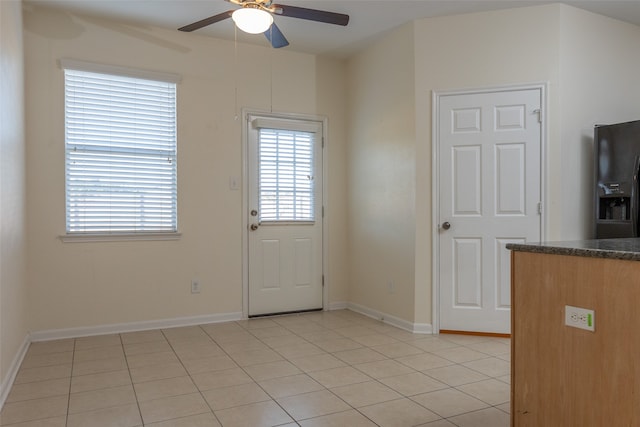 entryway with ceiling fan and light tile patterned floors