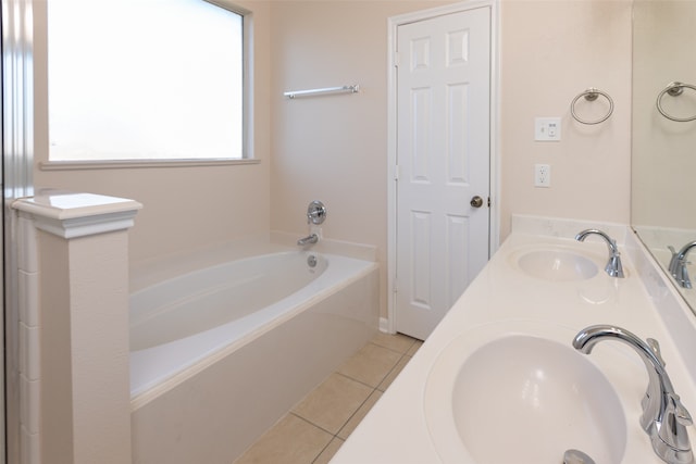 bathroom with vanity, a tub to relax in, and tile patterned flooring