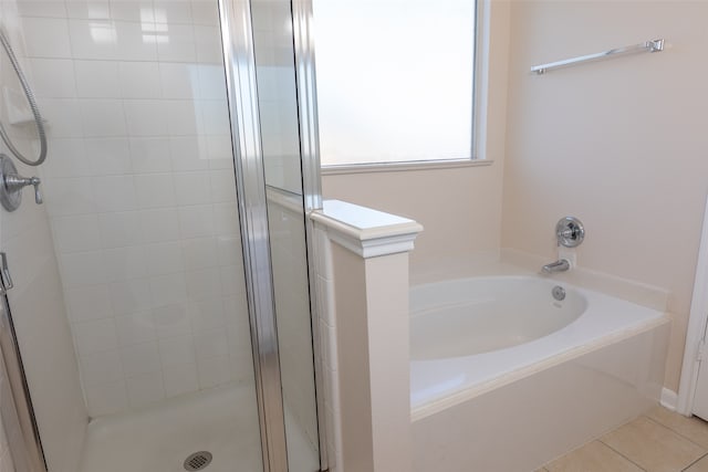 bathroom with separate shower and tub and tile patterned flooring