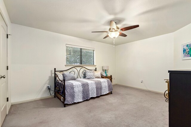 bedroom featuring ceiling fan and light colored carpet