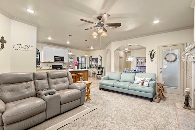 living room with ceiling fan, light colored carpet, and ornamental molding