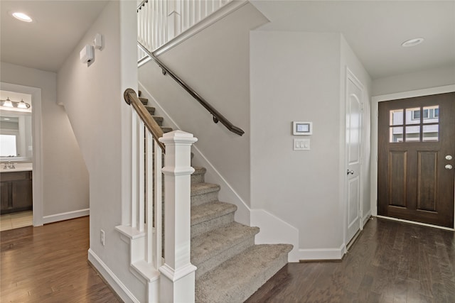 foyer entrance featuring dark hardwood / wood-style flooring and sink