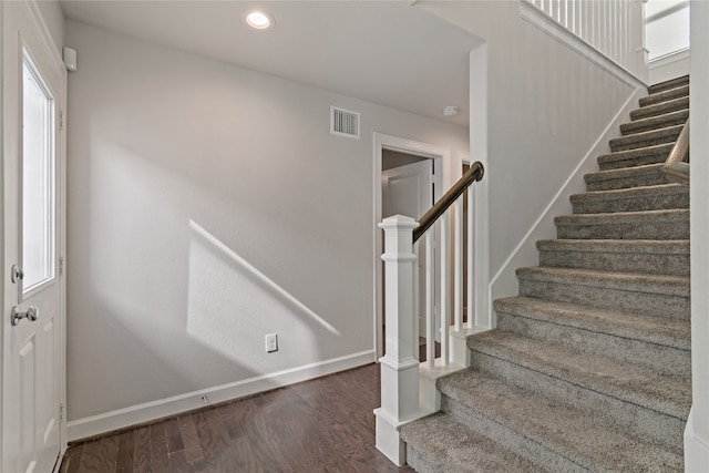 stairway featuring wood-type flooring