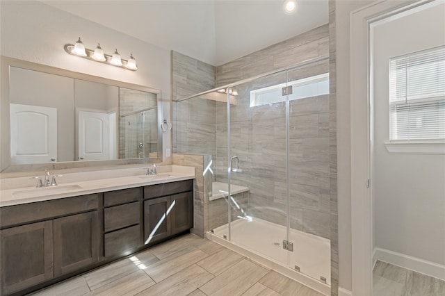 bathroom featuring walk in shower and vanity