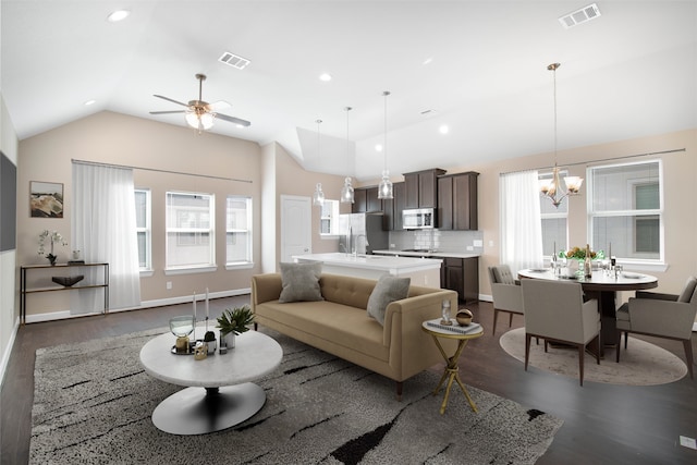 living room featuring ceiling fan with notable chandelier, dark hardwood / wood-style flooring, and lofted ceiling