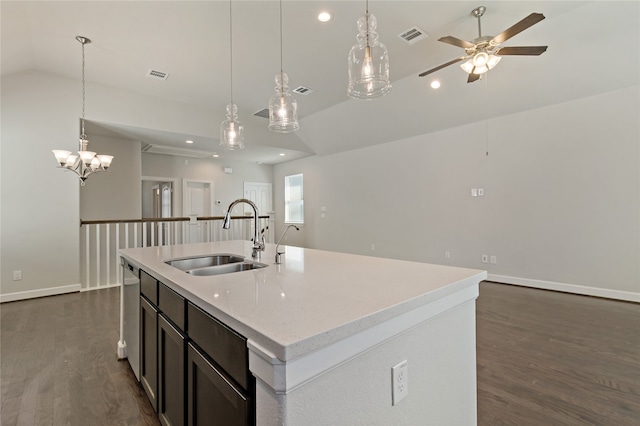 kitchen featuring dark hardwood / wood-style flooring, vaulted ceiling, sink, a kitchen island with sink, and pendant lighting