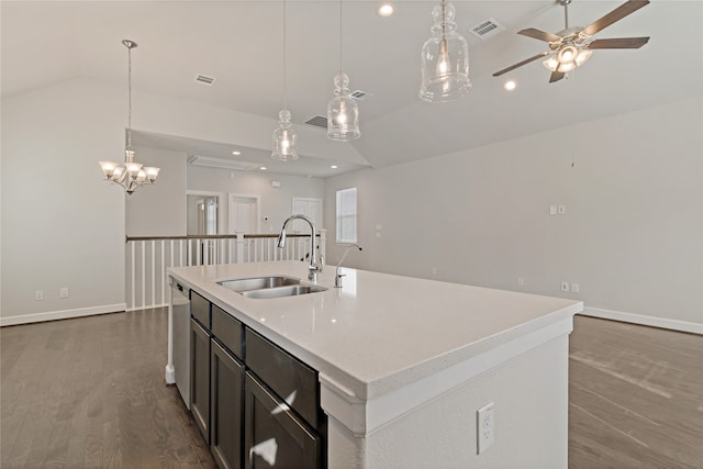 kitchen with a center island with sink, decorative light fixtures, hardwood / wood-style floors, sink, and vaulted ceiling