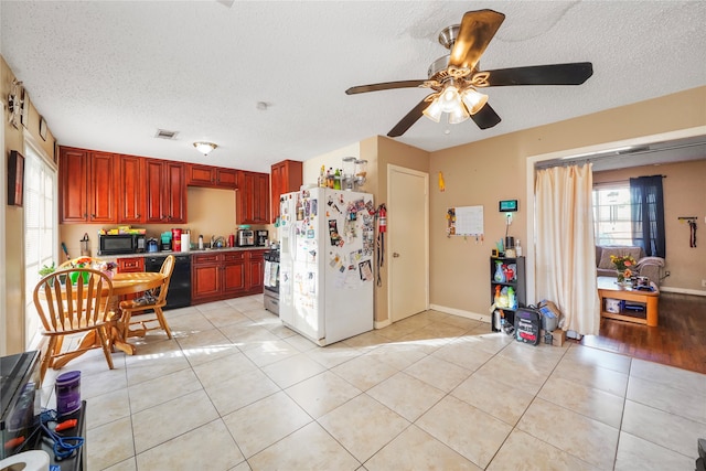 kitchen with light tile patterned flooring, sink, black appliances, ceiling fan, and a textured ceiling