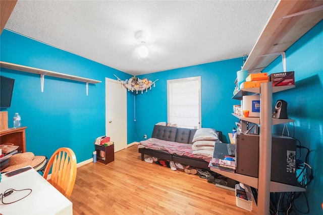 3120 Redfield Dr, Pasadena, TX 77503 - home office with wood finished floors, a textured ceiling, and baseboards