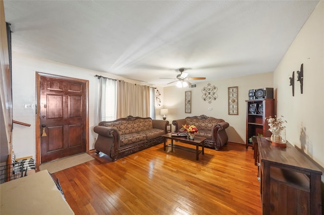 living room with ceiling fan and light hardwood / wood-style floors