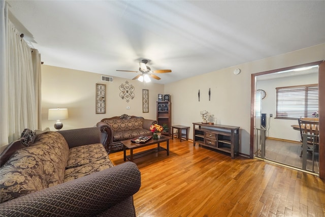 living room with hardwood / wood-style floors and ceiling fan