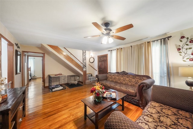 living room with ceiling fan and light hardwood / wood-style floors