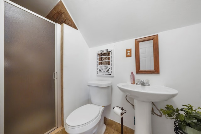 bathroom featuring toilet, an enclosed shower, and tile patterned floors