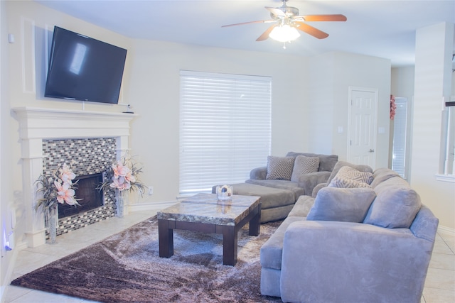 tiled living room featuring a tiled fireplace and ceiling fan