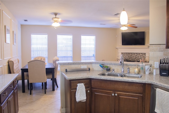 kitchen featuring dark brown cabinetry, sink, and ceiling fan