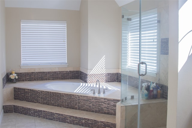 bathroom featuring tile patterned flooring and separate shower and tub