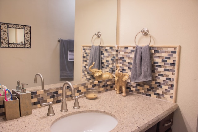 bathroom featuring decorative backsplash and vanity