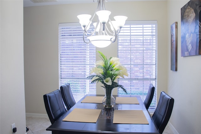 dining area featuring an inviting chandelier and light tile patterned flooring