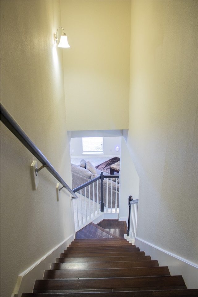 stairs featuring hardwood / wood-style floors