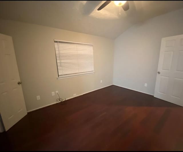 16703 Sentinel Dr, Houston, TX 77053 - empty room with vaulted ceiling, a ceiling fan, and dark wood finished floors