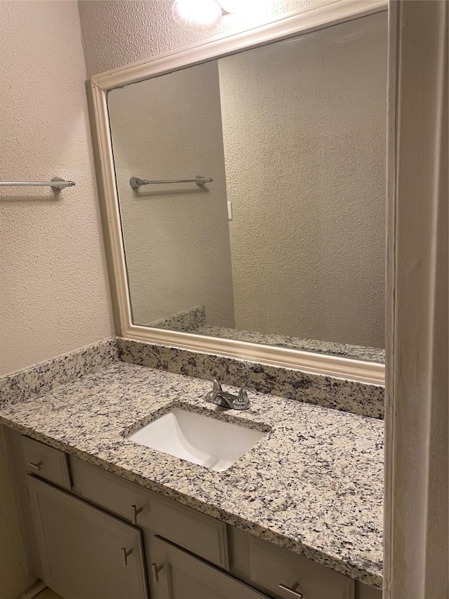16703 Sentinel Dr, Houston, TX 77053 - bathroom with vanity and a textured wall