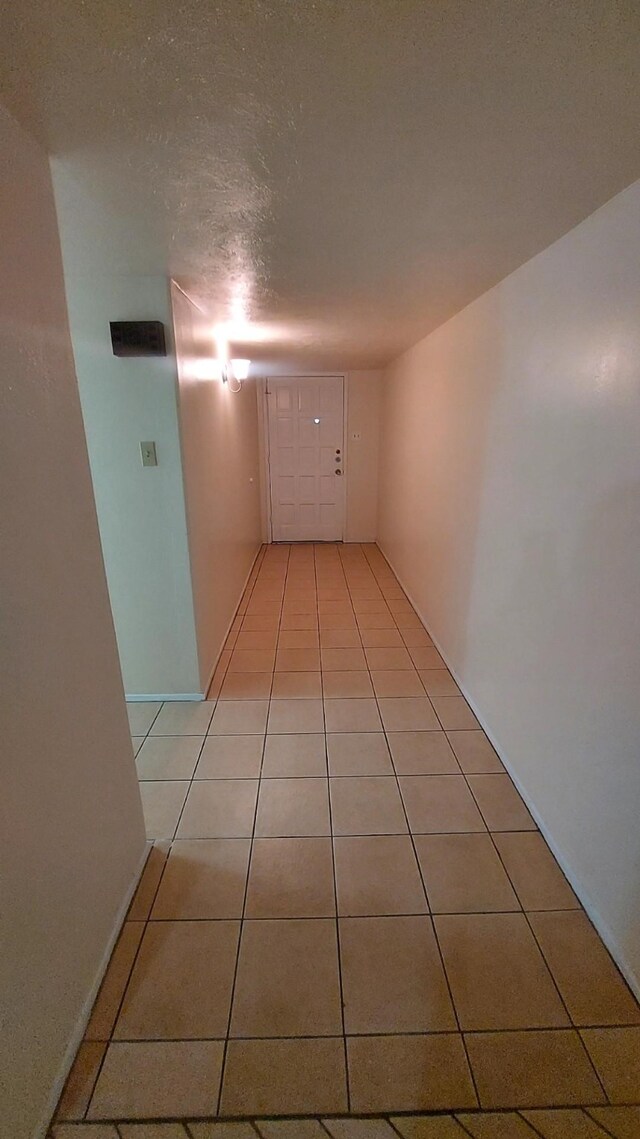 hallway with light tile patterned floors