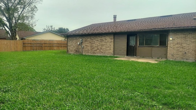 rear view of house with a yard