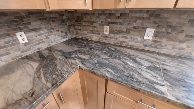 details with light brown cabinets and tasteful backsplash