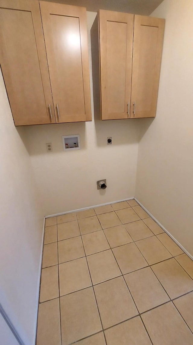 laundry area with hookup for a washing machine, light tile patterned floors, cabinets, and hookup for an electric dryer