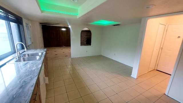 5538 W Ridgecreek Dr, Houston, TX 77053 - kitchen featuring a sink, light tile patterned floors, a tray ceiling, and light countertops