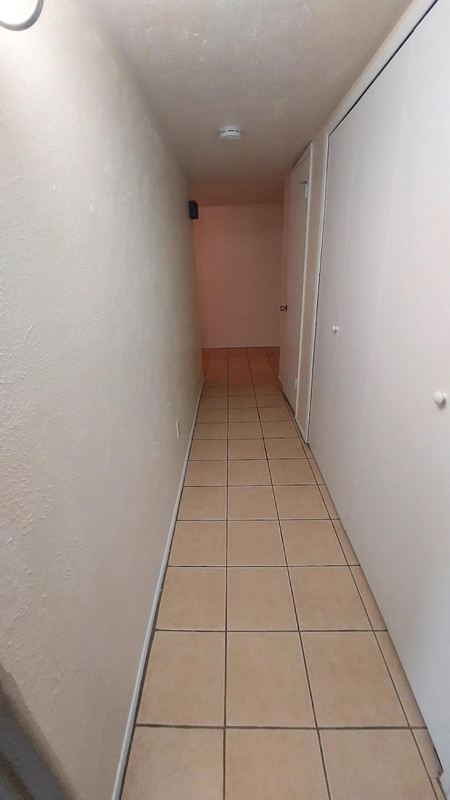 corridor with light tile patterned floors