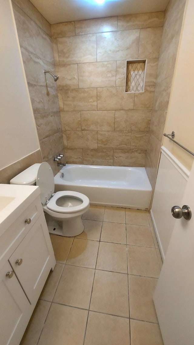 full bathroom featuring tile patterned floors, vanity, toilet, and tiled shower / bath