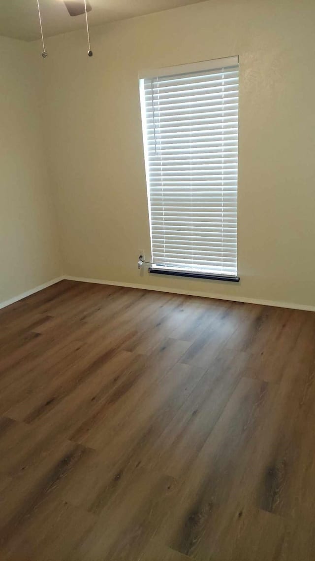 spare room with dark wood-type flooring