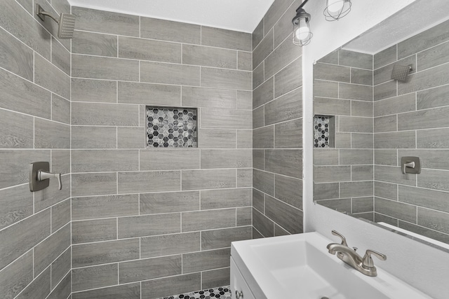 bathroom featuring vanity and a tile shower