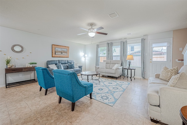 living room with light tile patterned flooring and ceiling fan