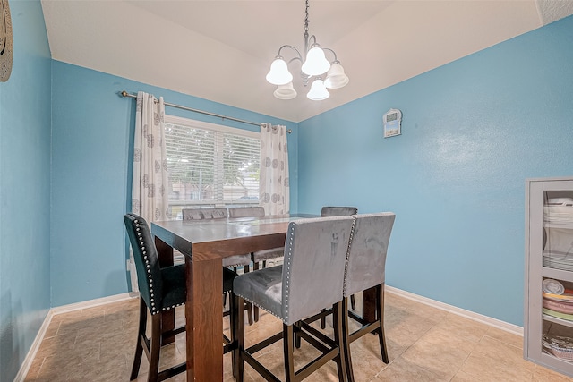 tiled dining area featuring a chandelier