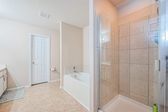 bathroom featuring independent shower and bath, vanity, a textured ceiling, and tile patterned floors