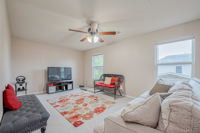 carpeted living room with ceiling fan