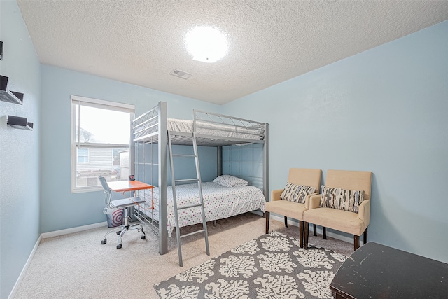 carpeted bedroom featuring a textured ceiling