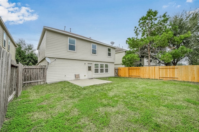 rear view of house featuring a yard and a patio area