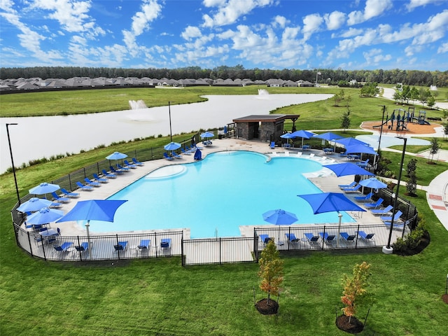 view of pool featuring a yard and a water view