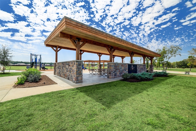 surrounding community featuring a lawn, a gazebo, and a bar