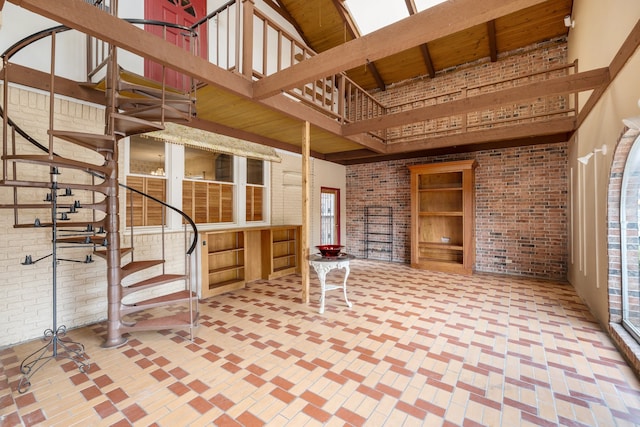 interior space with a high ceiling and brick wall