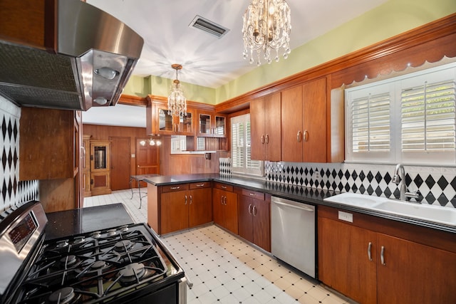 kitchen featuring an inviting chandelier, pendant lighting, sink, and stainless steel appliances