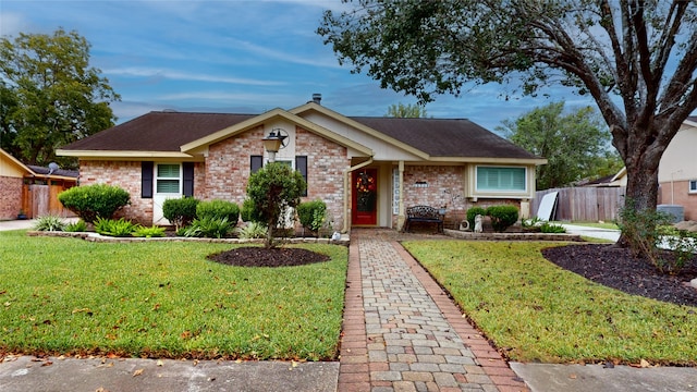 single story home featuring a front lawn