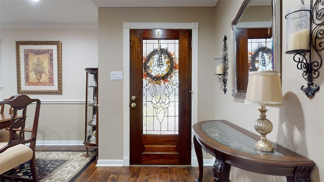 entryway with a healthy amount of sunlight, dark hardwood / wood-style flooring, and ornamental molding