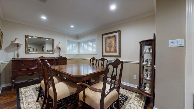 dining room with wood-type flooring and crown molding