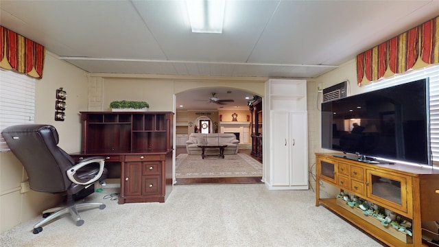 home office featuring light carpet and ceiling fan