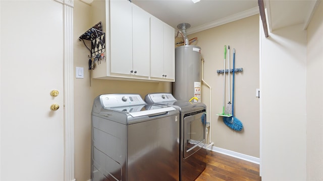 clothes washing area with crown molding, water heater, cabinets, dark wood-type flooring, and washer and dryer